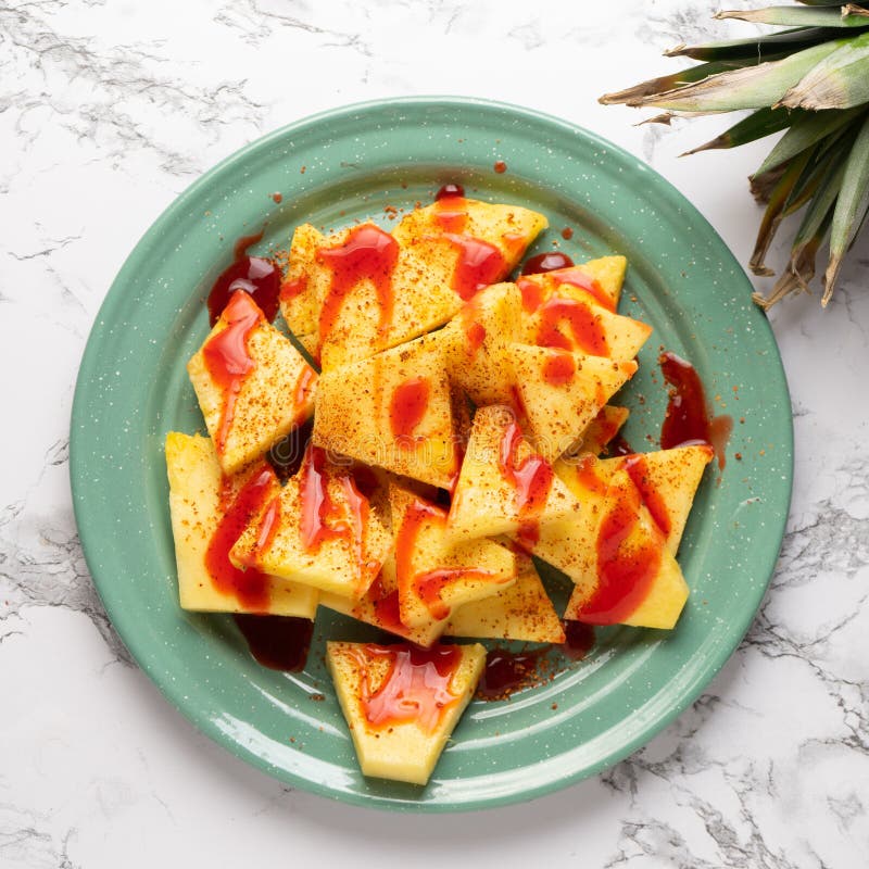 Pineapple with Chili Powder and Chamoy. Mexican Food Stock Photo