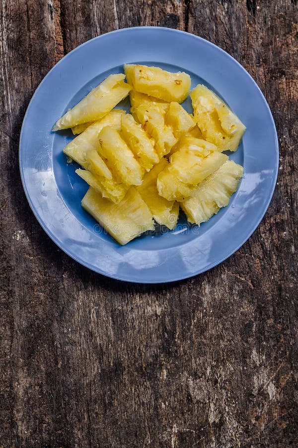 Pineapple Cut into Pieces, Arrange Them in a Blue Plate. Stock Photo Image of arrange, pieces