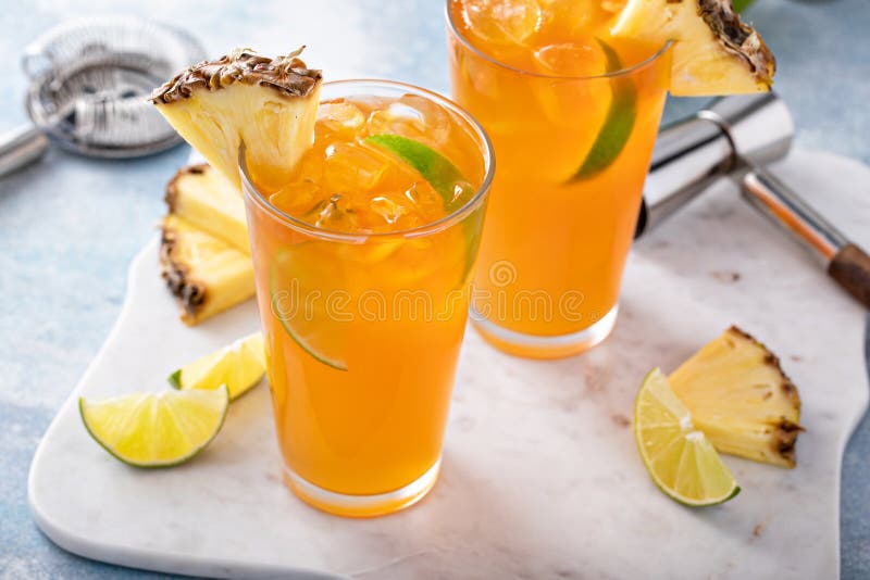 Pineapple Rum Cocktail with Lime Slices, Refreshing Summer Cocktail