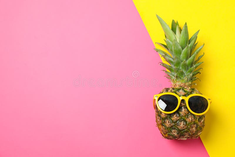 Pineapple with sunglasses on two tone background, space for text