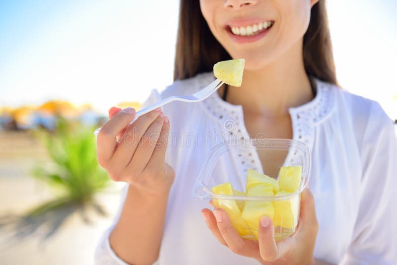 Pineapple - woman eating sliced Hawaiian fruit