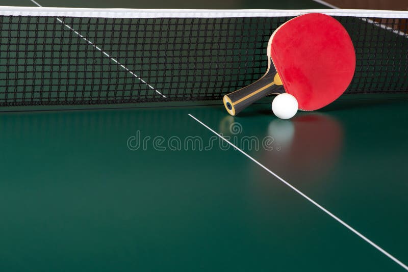 Pingpong Racket and a Ball on a Green Table. Pingpong Net Stock Image