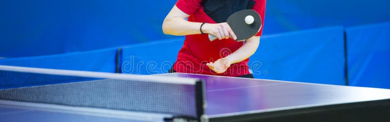 Ping pong table, woman playing table tennis with racket and ball in a sport hall