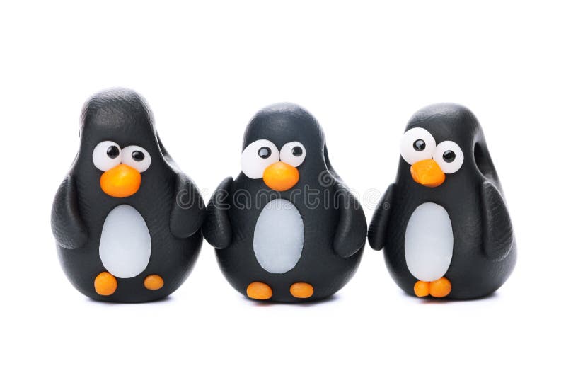 Pinguins made of polymer clay isolated on white background