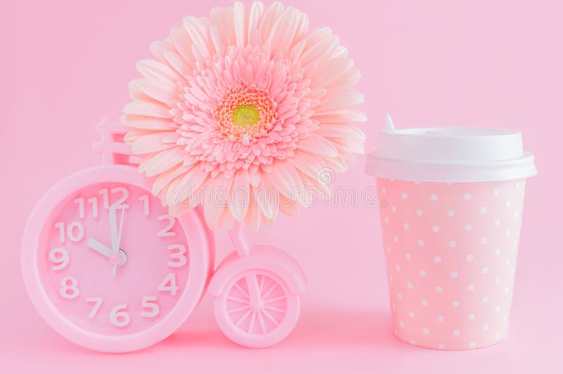 Pink alarm clock, glass of coffee take-away and gerbera flower on pink background. Good morning or coffee time concept. Postcard royalty free stock photo Pink alarm clock, glass of coffee take-away and gerbera flower on pink background. Good morning or coffee time concept. Postcard royalty free stock photo