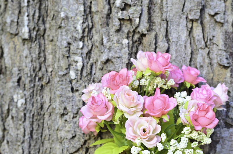 Pink Artificial Rose Bouquet With Tree Trunk Background Stock Image