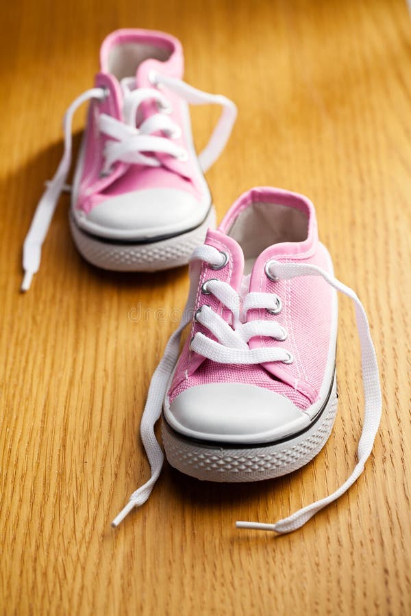 Pink baby sneakers royalty free stock image