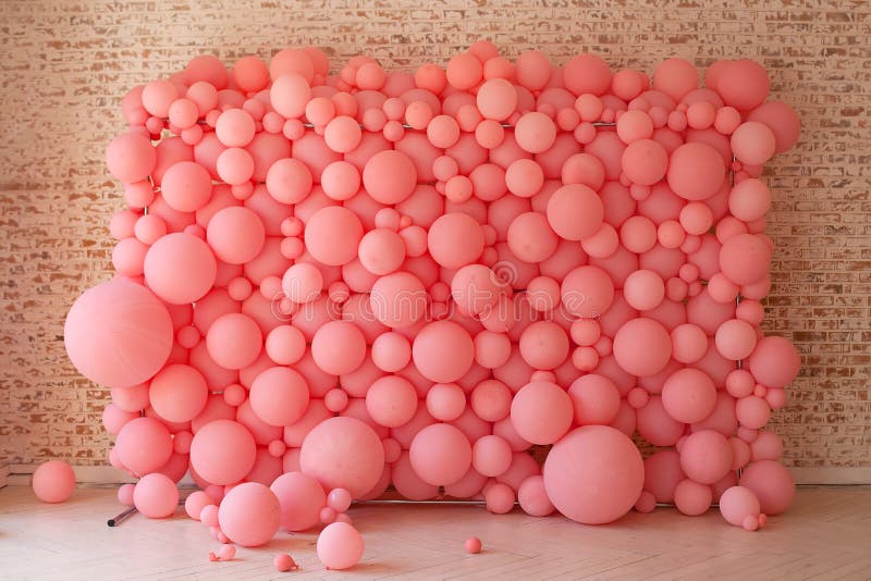 Pink balloons, pink bubbles beautiful birthday texture. Wall decor for a party. Decorated wall for the holiday. Cells under the microscope, macrocell division. Decorated brick wall with balloons.