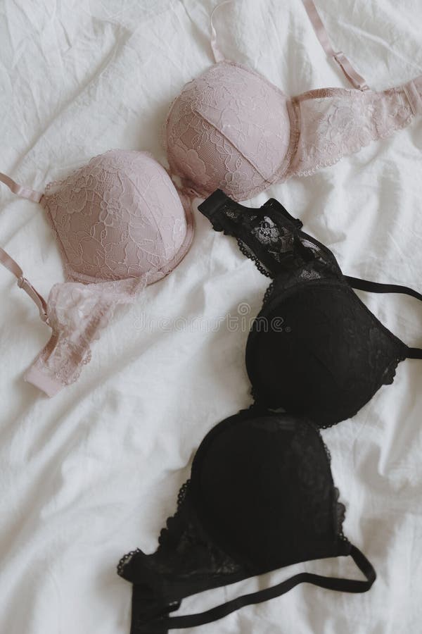 Pink and Black Bras on a Bed Stock Photo - Image of lingerie, white:  222629910