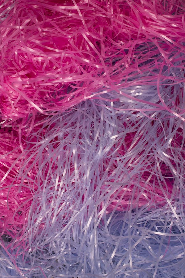 Pink and Blue Shredded Plastic Fake Easter Grass Background Stock Photo