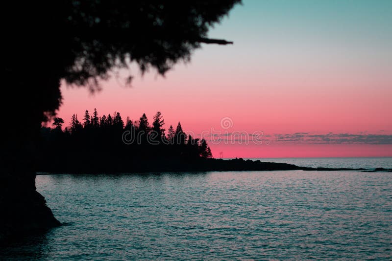 Pink and blue skies illuminate a silhouetted peninsula at Split Rock State Park in Northern Minnesota