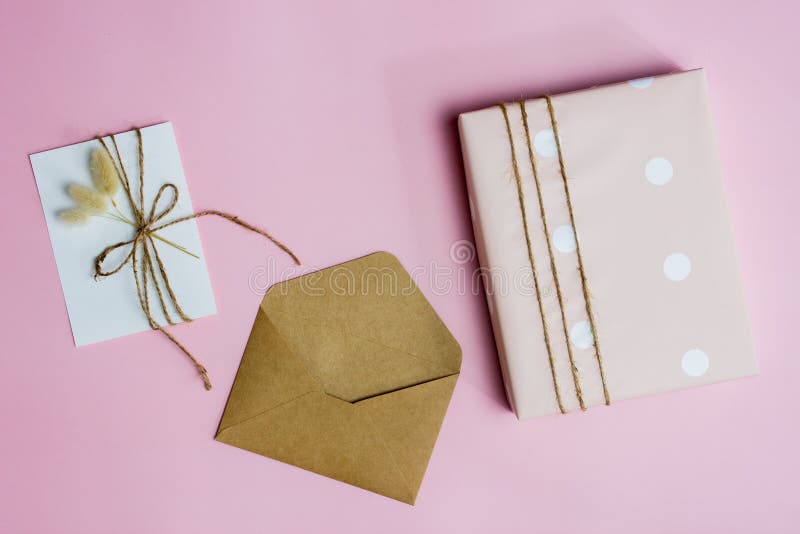 A pink box, letter and envelope over the pink background. stock photography