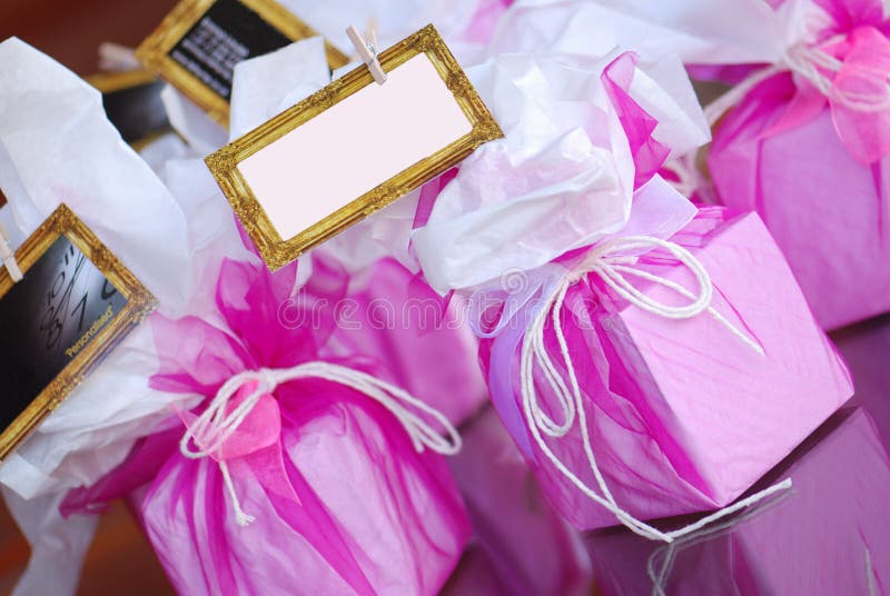 Box shaped party favours wrapped in pink crepe and with space for writing a personal message. Box shaped party favours wrapped in pink crepe and with space for writing a personal message