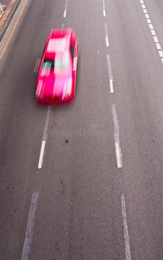 Pink car running on the road