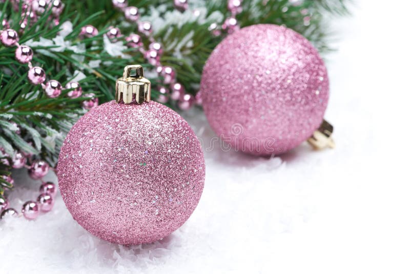 Pink christmas balls and spruce branches, selective focus