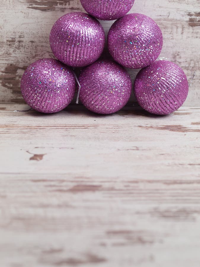 Pink Christmas Balls in a Stack Over Wooden Background Stock Image