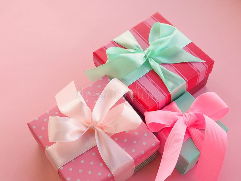 Pink Christmas Gift with Ribbon, on Pink Background Stock Photo Image