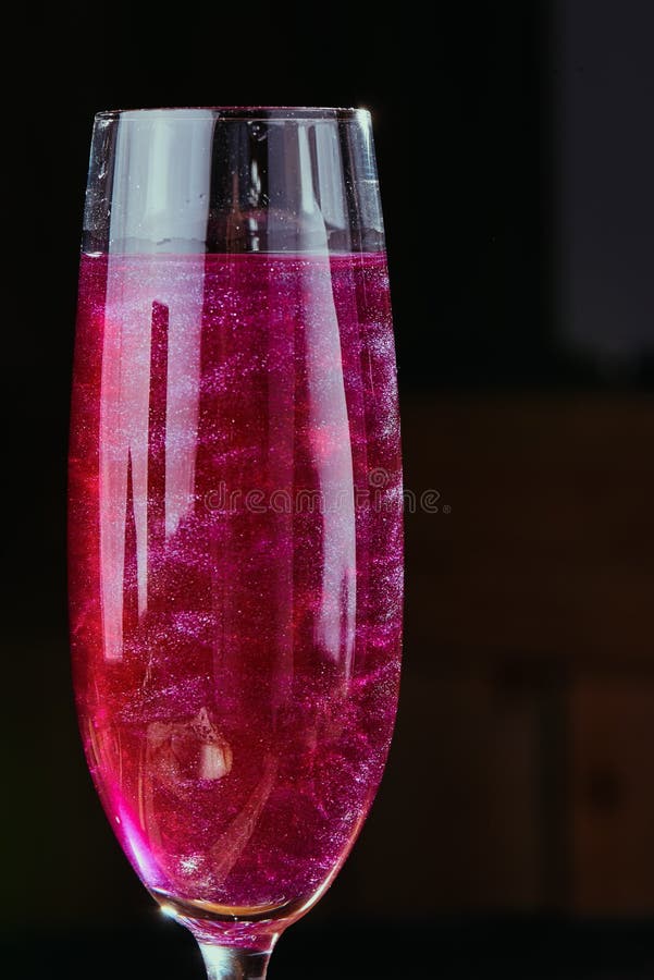 Pink Cocktail with Glitter in a Beautiful Glass of Flute Isolated on a Dark  Background. Stock Photo - Image of purple, cosmopolitan: 131622714