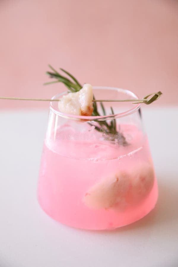 Pink Cocktail with Rosemary and Lychee in Pink Background Stock Photo