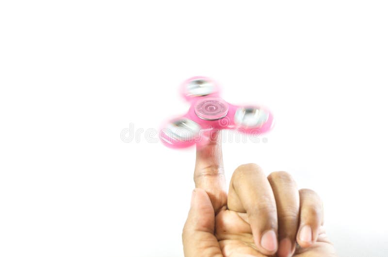 Pink color fidget spinner on hand moving stock photography