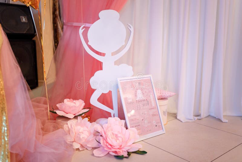 Pink decorative flowers, paper ballerina shape and baby girl metric with name Arina, date of birth, height and weight