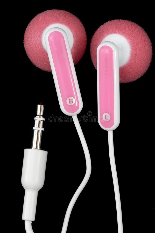 Pink Earbuds Closeup, macro, on white with wires and stereo plug, on black background. Pink Earbuds Closeup, macro, on white with wires and stereo plug, on black background