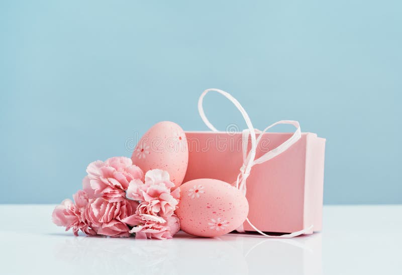 Pink Easter Eggs with Gift Box and Carnations Spring Flowers on Blue ...