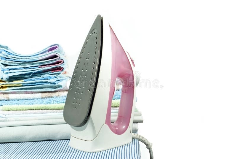 pink electric iron and a stack of ironed clothes on an ironing