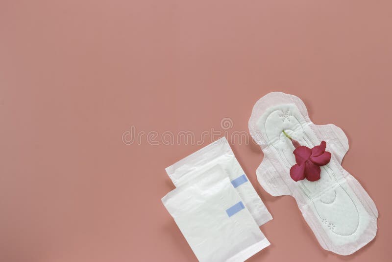 Pink flower on women`s hygiene products or sanitary pad on pink background stock photos Pink flower on women`s hygiene products or sanitary pad on pink background stock photos