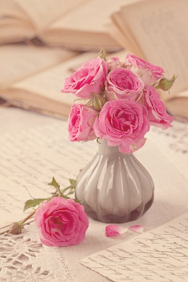 Pink flowers, letters and books