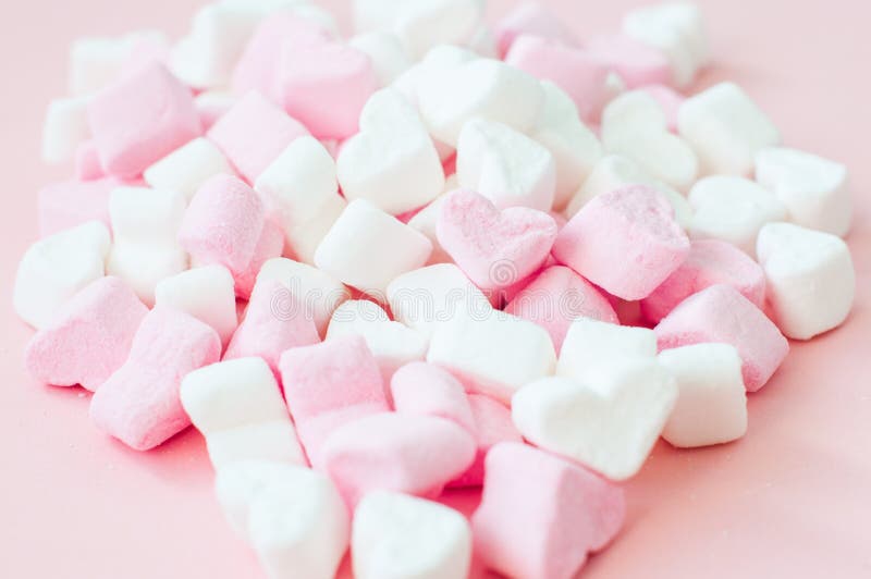 Pink heart-shaped marshmallows in with pink background Stock Photo