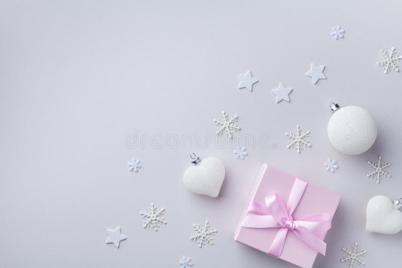 Pink gift box and white Christmas decorations on pastel background. Christmas, winter or New year holiday card top view. Flat lay stock image Pink gift box and white Christmas decorations on pastel background. Christmas, winter or New year holiday card top view. Flat lay stock image
