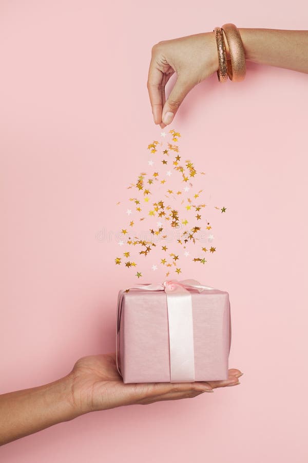 Pink Gift and Falling Confetti on Pastel Pink, Minimal Background
