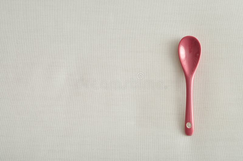 A pink glass teaspoon