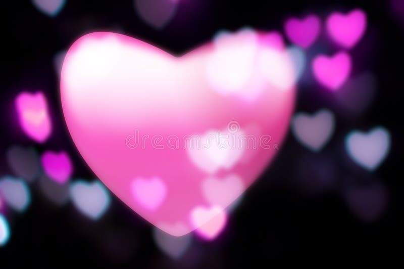 Pink heart blurs into out-of-focus lights