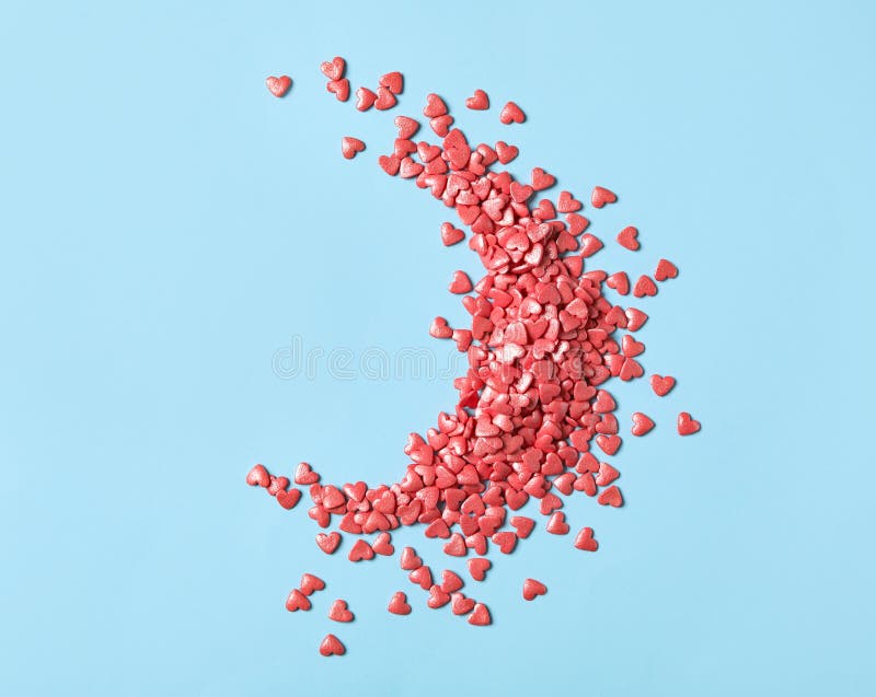 Pink Heart Shaped Sprinkles on Light Blue Background, Flat Lay Stock