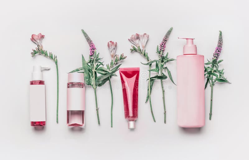 Pink herbal natural facial cosmetic products set with herbs and flowers on white background stock photos Pink herbal natural facial cosmetic products set with herbs and flowers on white background stock photos