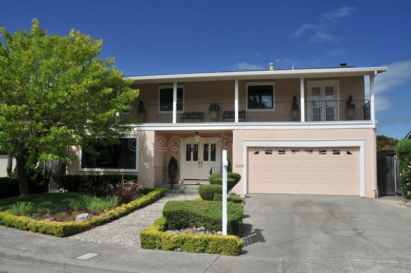 Pink house with tree in front stock photos