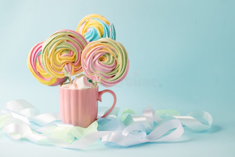 Pink marshmallow in heart shape stacked on blue wood table with copy space. Sweet candy for love theme on Valentine concept in