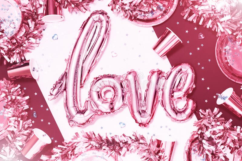 Pink metallic love word foil balloon on party table stock photos Pink metallic love word foil balloon on party table stock photos
