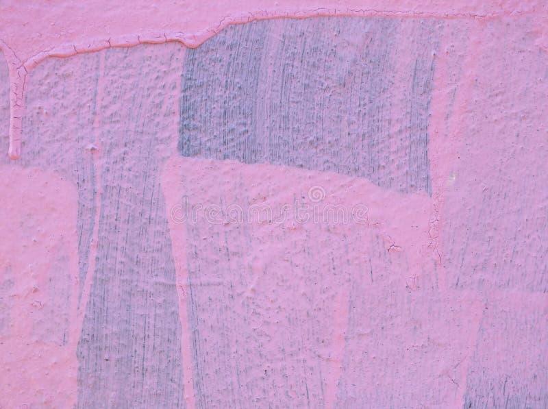 Pink paint on a wall with drips and brush marks with the original blue color showing underneath