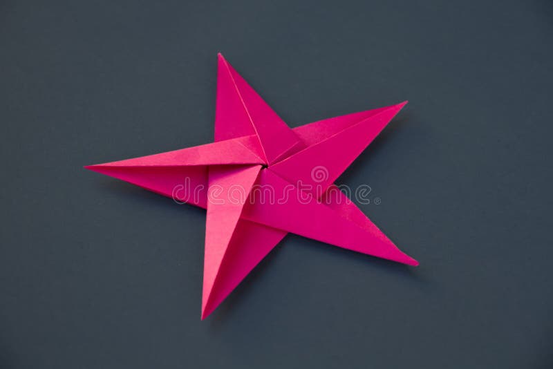 Pink Paper Star Origami Isolated on a Grey Background Stock Image