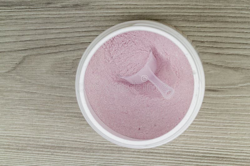 Pink Protein Powder with Spoon in Wooden Background Stock Photo Image