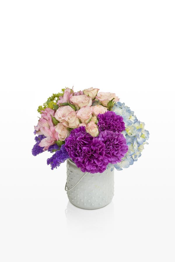 Pink and purple flower arrangement. Roses and hydrangea in a white vase designed for florist.