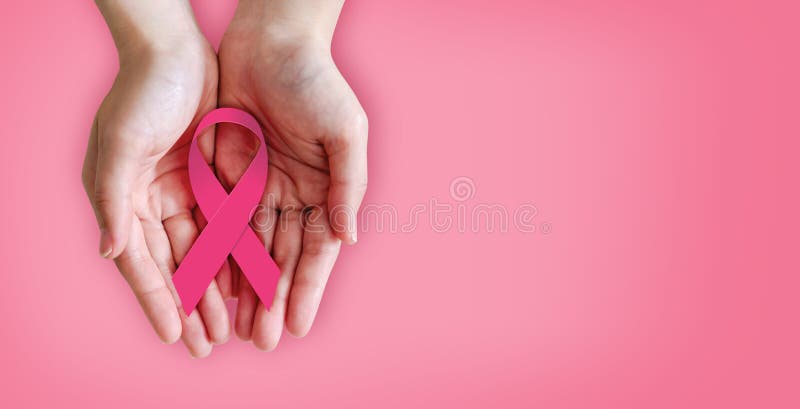 Pink ribbon on hands for breast cancer awareness