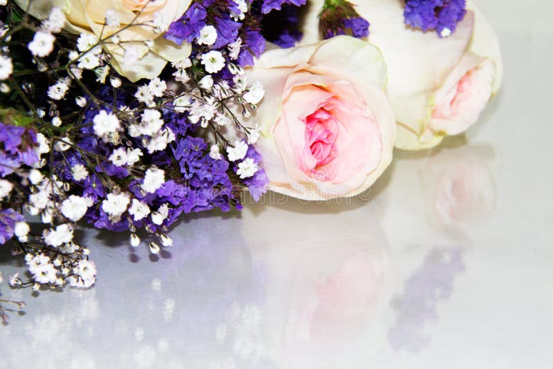 Small purple flowers mixed in with white baby`s breath and pink roses in a bouquet stock images Small purple flowers mixed in with white baby`s breath and pink roses in a bouquet stock images