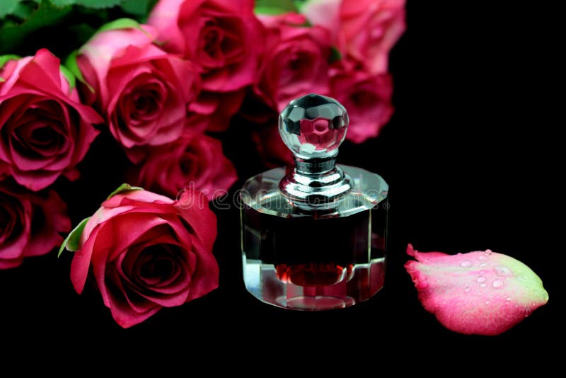 Pink roses and perfume. On black background stock photos Pink roses and perfume. On black background stock photos
