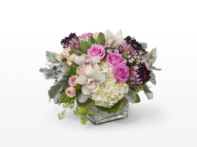 Unique mixed flower arrangement with pink Roses, pink Protea, and white Orchids.