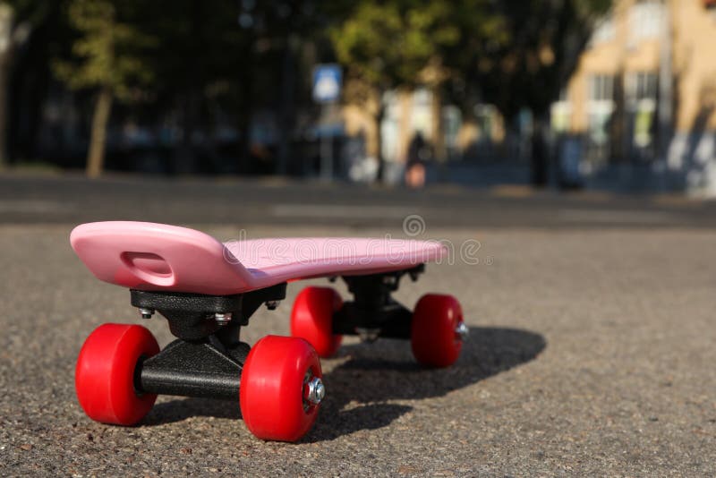 Pink Skateboard with Red Wheels on Asphalt Outdoors Stock Image Image