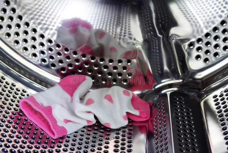 A single pink sock forgotten inside of the washing machine drum. Metal steel drum stock images, royalty-free photos and pictures